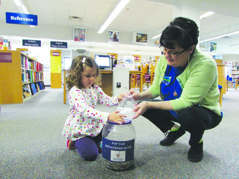 Gemma donates pop tabs for the Ronald McDonald House at the Peebles Library, in honor of her twin brother Keller, who is battling cancer.