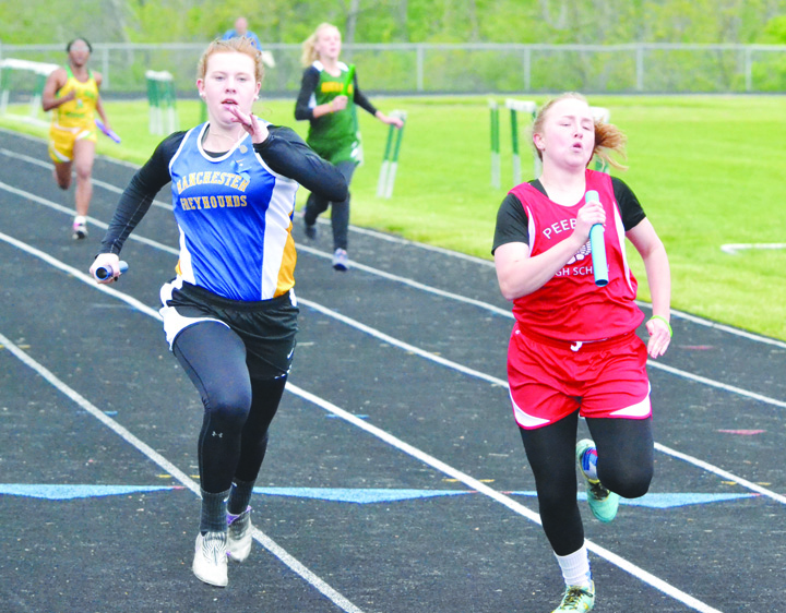 It was a race to the finish line in the Girls 4 x 100 Relay between Manchester’s Katie Fetters, left, and Peebles’ Breauna Shoemaker, right. Shoemaker got the best of the battle as the anchor of the Indians’ quarter, winning the race in a time of 56.37. The Manchester foursome recorded a finish time of 56.62. Photo by Mark Carpenter.