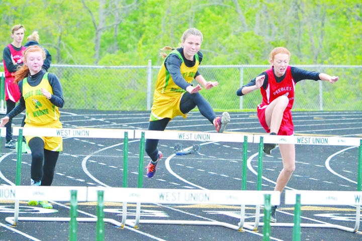 West Union’s Rebekah McCarty, center, leads the way on her way to victory in the Girls 100 M Hurldes in last week’s Adams County Track Meet. Photo by Mark Carpenter.