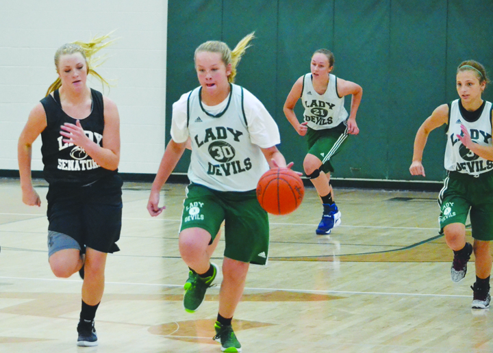 North Adams' Courtney Brown heads up court with teammates trailing in action from the June 24 JV Shootout.