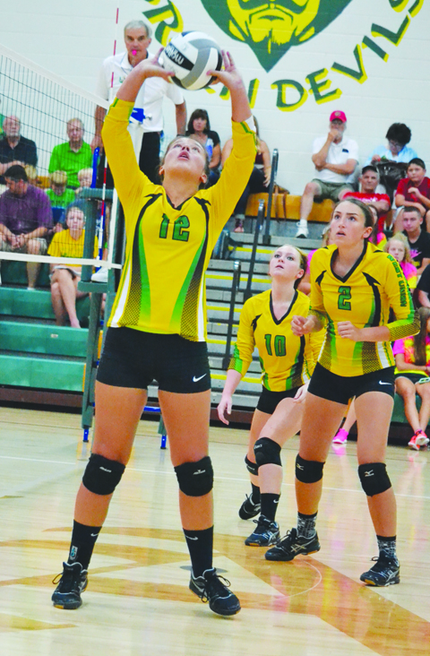 With teammates Houston Adkins (2) and Gloria Purdin (10) ready for backup, West Union’s Kiersten Rowe (12) sets the ball during action form the 2016 SHAC Preview.