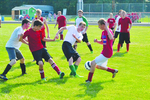It looks as if nearly everyone on the field is involved in this play for the ball during action from last Friday night’s pre-season soccer scrimmage between West Union and Peebles.