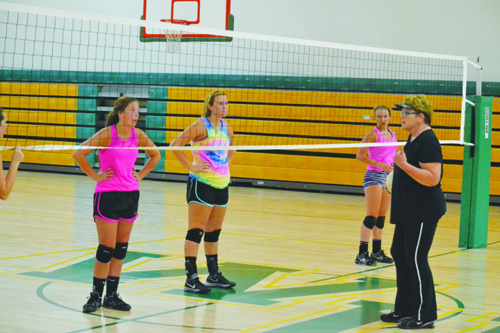 West Union varsity volleyball coach Debbie McClanahan gives instructions to her squad on Monday night, the first official day of practice for volleyball teams.