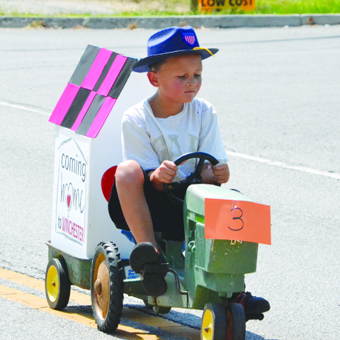 Coming home to Winchester was the theme for a weekend of activities and celebrations as this young man proudly displayed with his parade vehicle.