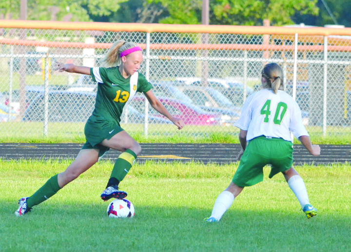 North Adams’ Jessica Woodall (8) battles for possession with West Union’s Anna Shupert during Monday’s girls soccer action. Woodall scored two second half goals and Shupert had the only West Union goal in a 9-1 Lady Devils’ win.
