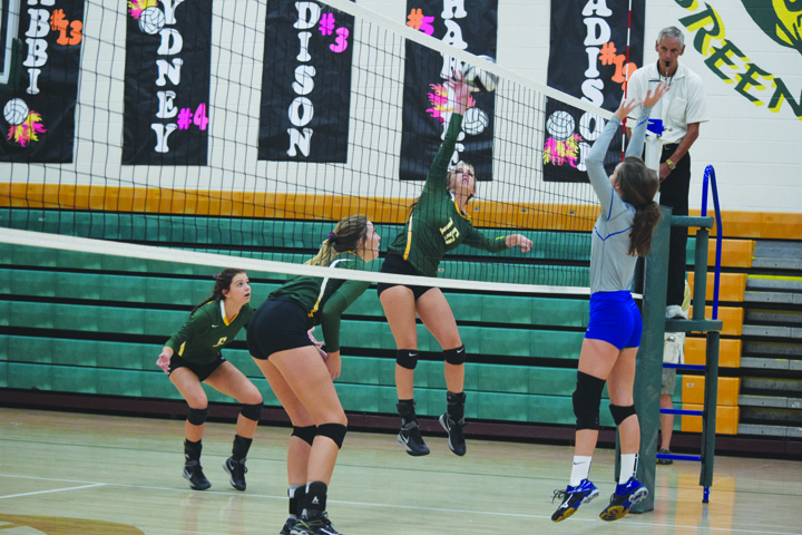 With Manchester’s Abby McFarland in position to block, North Adams’ Brooklyn Stout goes up for the kill attempt in action from last Tuesday night’s match.