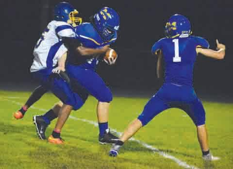 After a pass attempt by Jefferson quarterback Thomas Herron was batted in the air by Manchester’s Marcus Neeley (1), it was intercepted by teammate Jacob Calvert in the second quarter of Friday’s Greyhound win. Here, Herron tries to drag Calvert to the ground on the interception return.