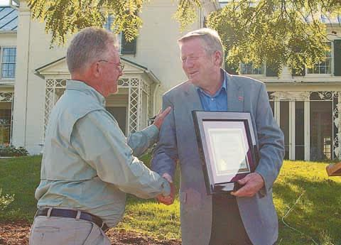 Tom Cross, left, accepts the ODNR Cardinal Award from ODNR Director James Zehringer.