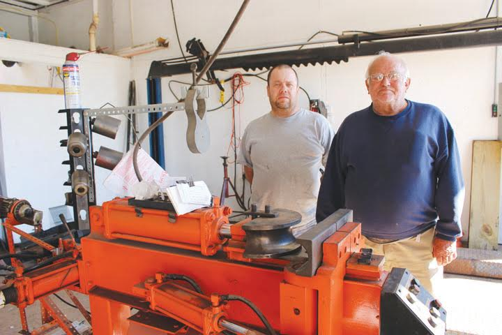 John Rideout, right, and his son Brian, will be celebrating their 40th year of being in the muffler business this month.