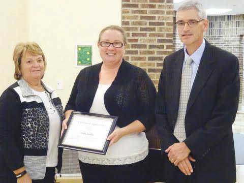 Peebles Elementary teacher Polly Spiller was recently honored by the ACOVSD Board of Education for her heroic actions in saving a student from choking. Spiller, center, is pictured here with board member Judy Campbell and Superintendent Richard Seas.