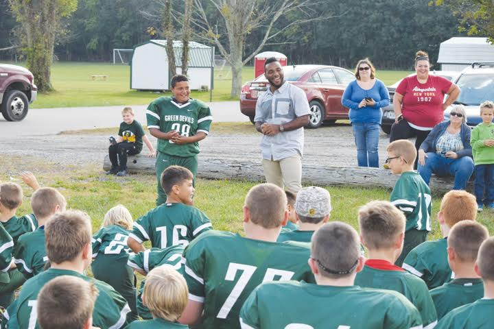 Adams County Sheriff Kimmy Rogers and a group of his Junior Deputies pose with Bengals running back on Saturday night. Bernard was very good to the young men, making sure all of them went home with some type of autographed item.