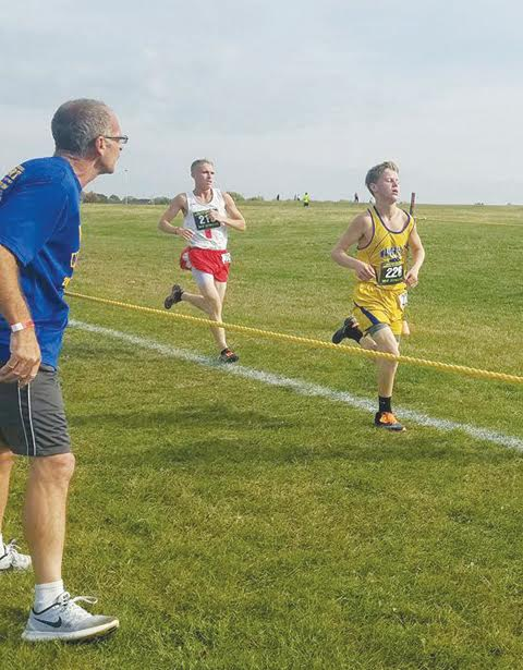 Manchester junior Ethan Pennywitt, right, cheered on by father Lonnie Bilyeu, will become the first Greyhound in the school’s history to compete in the state cross-country meet this Saturday at National Trail Raceway.