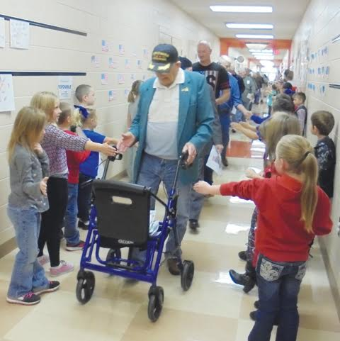 Peebles Elementary students line the hallways to greet the veterans as part of the school’s annual Veterans Day parade.