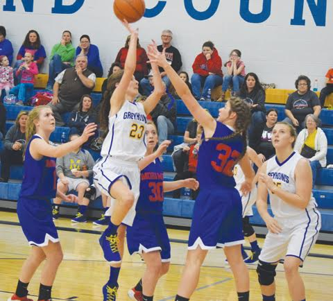 Manchester’s Emily Sweeney (23) glides through the lane between Northwest defenders for this shot attempt in action from the eighth grade girls basketball game Nov. 28 in Manchester. Sweeney scored 10 points in a 49-27 win for the Lady Hounds.