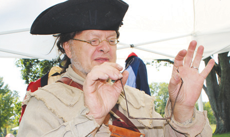 This 18th century re-enactor told stories of life on the frontier as part of the annual Archaeology Day at Serpent Mound.