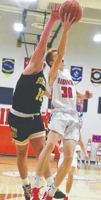 <p>Peebles’ Cory Reed eludes a Paint Valley defender to get off this first half layup attempt as the Indians battled Paint Valley in non-conference play on December 7. (Photo by Mark Carpenter)</p>
