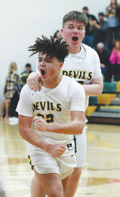North Adams Avery Anderson and Dillon Ragan celebrate the Devils 45-44 win over Minford on February 12. (Photo by Tim Daulton)