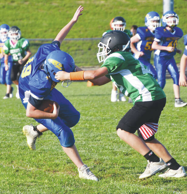 The horse collar penalty flag flew on this play as Manchester quarterback Clayton Colvin was hauled down by a Fayetteville defender in action from last weeks junior high match up at Veterans Stadium. (Photo by Mark Carpenter)