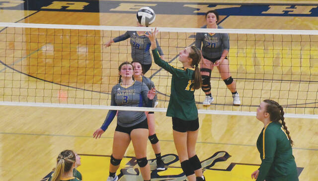With the left hand, North Adams Keetyn Hupp guides a return over the net in the Lady Devils September 8 win at Manchester. (Photo by Mark Carpenter)