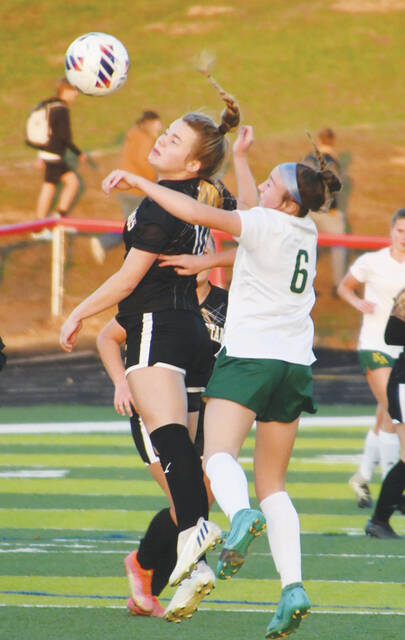 North Adams freshman Carlee Garrison (6) goes airborne to battle for possession in this play from the Lady Devils loss to Lynchburg on November 1. (Photo by Mark Carpenter)