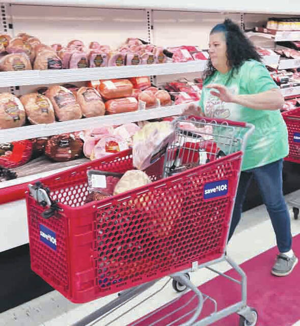 Shawna Wolfe makes her way to grab plenty of hams. (Photo by Sherry Larson)