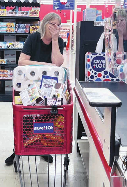A very happy Edith Heisler brings her Shop Til You Drop haul to the register. (Photo by Sherry Larson)