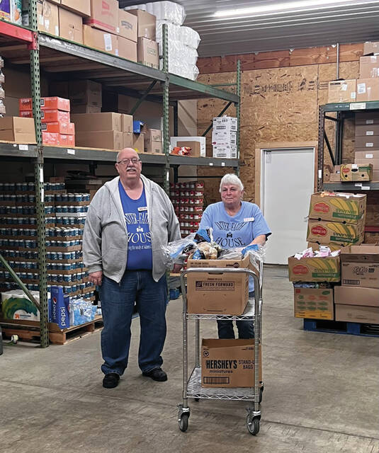 Interfaith House Executive Director Neal Kingery and Secretary/Treasurer of the Board Renee Velzka loading up in the Interfaith warehouse. (Photo by Sherry Larson)