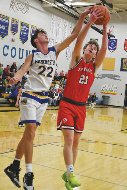 Manchesters Drew Kennedy (22) battles for a rebound with Fairfields TJ Mootz during the two teams SHAC battle in the Hound Pound on January 20. (Photo by Mark Carpenter)