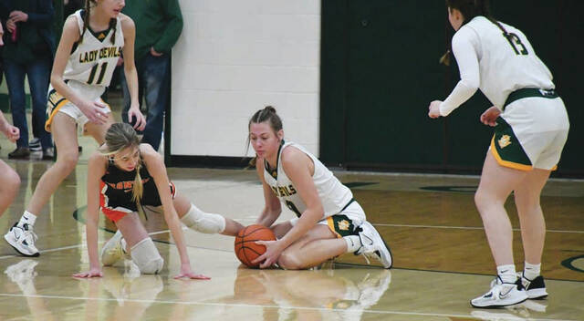 North Adams sophomore Katelynn Boerger turned in a fine all-around performance in Saturdays win over Ironton. Here, she hustles to the floor to retrieve a loose ball that resulted in a basket on the other end for the Lady Devils. Boerger scored 12 points as North Adams downed Ironton 50-30. (Photo by Mark Carpenter)