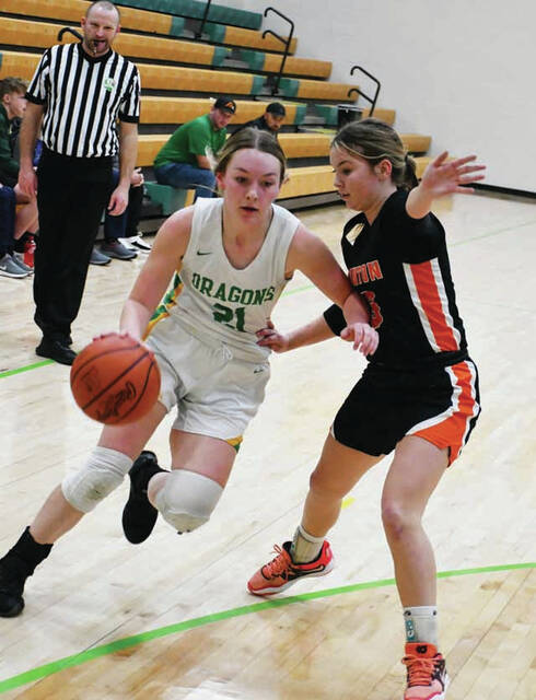 West Unions Olivia Lewis, left, looks for a path to the basket around an Ironton defender in the Lady Dragons sectional tourney loss on February 15. (Photo by Mark Carpenter)