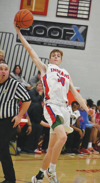 Peebles senior Cory Reed goes full extension to haul in an errant pass during the Tribes sectional tourney loss to Portsmouth on February 21. In his final game at PHS, Reed scored 10 points. (Photo by Mark Carpenter)