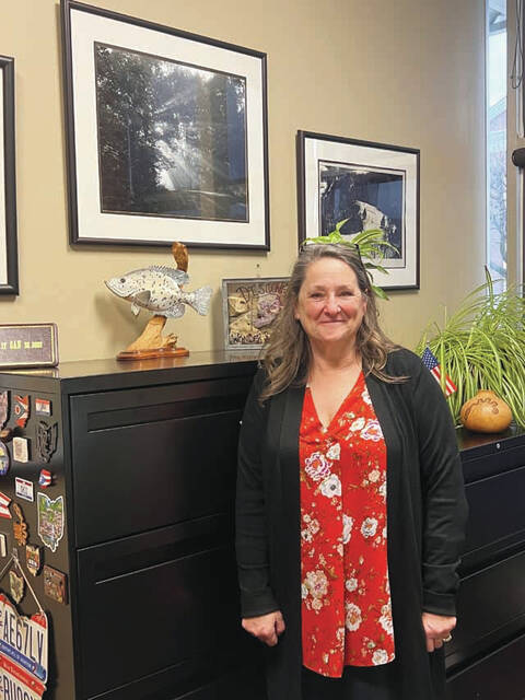 Holly Johnson, Adams County Director of Economic and Community Development, stands in front of her photograph of Sunshine Ridge. (Photo by Sherry Larson)