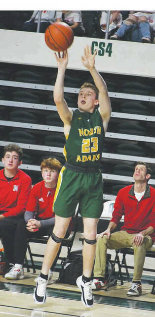 North Adams Breestin Schweickart launches a three-pointer from his favorite spot in the corner as he and the Green Devils downed Minford 54-46 to claim a Division III district championship, first for the boys program since 2009. (Photo by Mark Carpenter)
