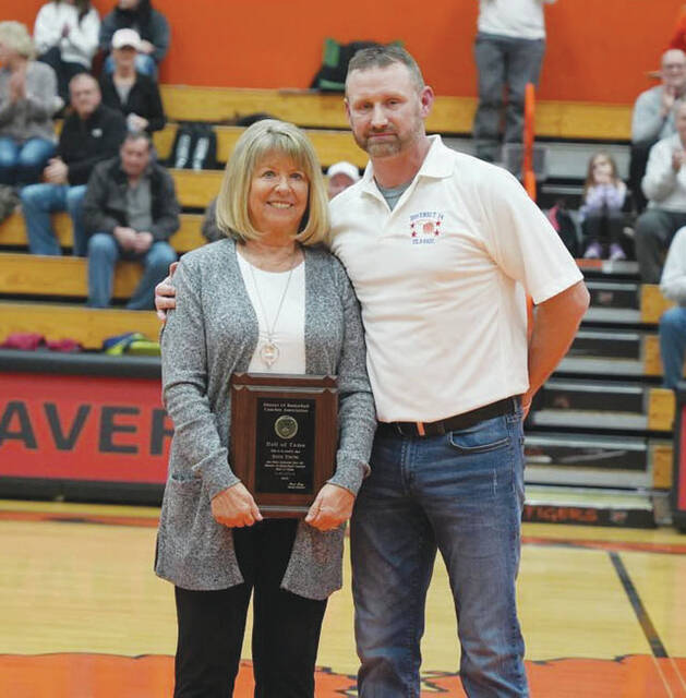 Nancy Young, wife of the late Dave Young, accepted her husbands Hall of Fame plaque from District 14 Basketball Director Josh Arey. (Photo provided)