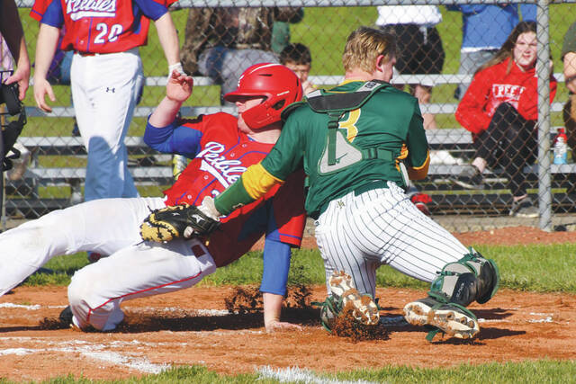 North Adams catcher Connor Rhodens tag is too late as Peebles Ethan Beekman slides home safely in action from Monday afternoon at NAHS. (Photo by Mark Carpenter)