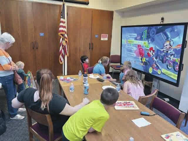 Families had fun playing Mario Kart at the Manchester Library Pizza Bash on May 18. The pizza was from S&G Pizza Pound