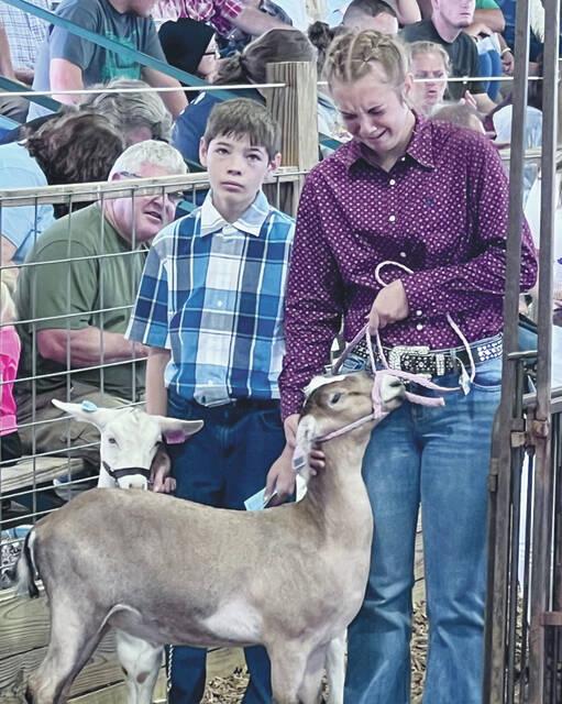 The emotions are evident as Ashlyn Abbott prepares to present her goat for sale. (Photo by Sherry Larson)