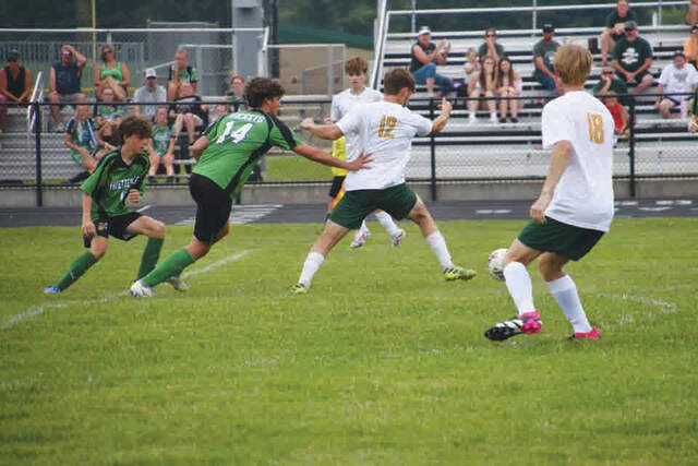 North Adams Gage White (12) tries to break free from the grasp of a Fayetteville defender as the Devils posted a 2-0 SHAC Preview win over the Rockets. (Photo by Mark Carpenter)
