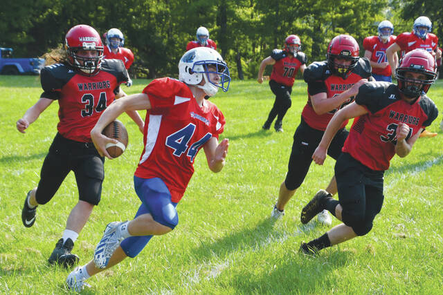Peebles Zane Knechtly races around the corner around Southern Buckeye defenders in action from the August 19 SOIL match up. Knechtly caught a pair of touchdown passes in a 56-8 victory over the Indians. (Photo by Mark Carpenter)