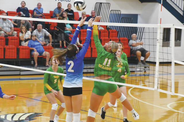 West Unions Korynne Blanton (11) battles at the net with Ripleys Kendra Padgett (2) as the two teams met in their season opener on Monday, August 21. (Photo by Mark Carpenter)