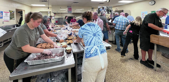 It takes the efforts of many volunteers to make the annual Junior Fair BBQ a delicious success. (Photo by Sherry Larson)