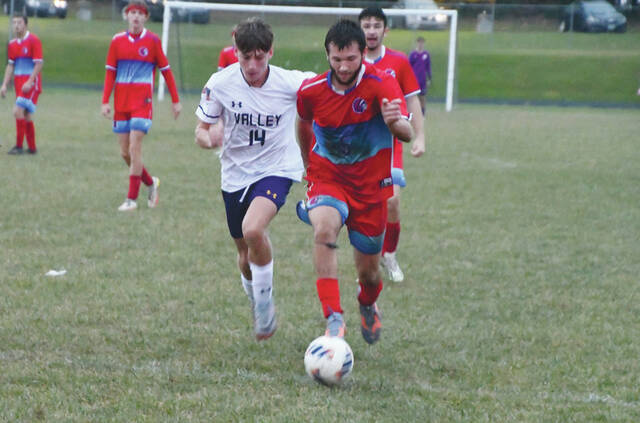 Peebles senior Waylen Lloyd navigates the sloppy and wet field to advance the ball up the field during the Indians 6-3 sectional tournament loss to Lucasville Valley. (Photo by Mark Carpenter)