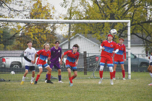 In front of their own net, the Indians attempt to clear the ball in action from their sectional final loss to Lucasville Valley. (Photo by Mark Carpenter)