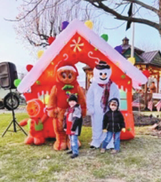 Children pose for photos with some of their favorite holiday characters. (Photo by Sherry Larson)