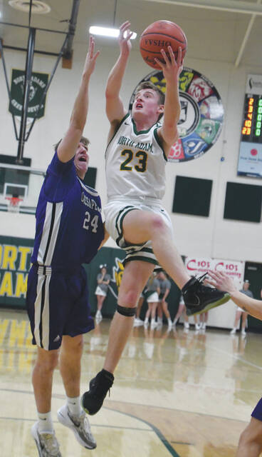 North Adams junior Breestin Schweickart goes around a Chesapeake defender for one of his patented acrobatic shots in the Devils Coach Young Classic 59-45 win. (Photo by Mark Carpenter)