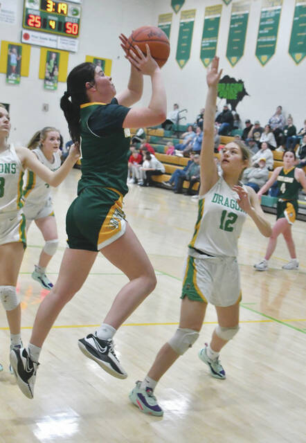 North Adams Tatum Grooms gets a shot off over the defense of West Unions Jocelyn Hall (12) in action from the Lady Devils conference win on February 8. (Photo by Mark Carpenter)