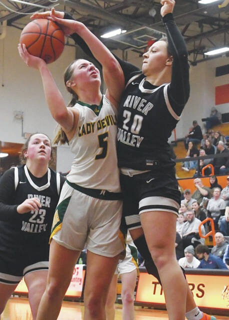 130408149_web1_Boerger-RV
North Adams junior Katelynn Boerger (5) draws the foul on a strong move to the bucket during the Lady Devils district semi-final win over River Valley. Boerger led the Lady Devils in the win with 18 points. (Photo by Mark Carpenter)
