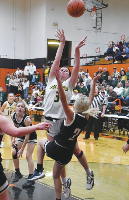 <p>North Adams’ Tatum Grooms (3) draws the block call on this play in the Lady Devils’ 54-36 win over River Valley on February 24. Grooms scored 12 as she and her squad moved to the Division III district title game. (Photo by Mark Carpenter)</p>