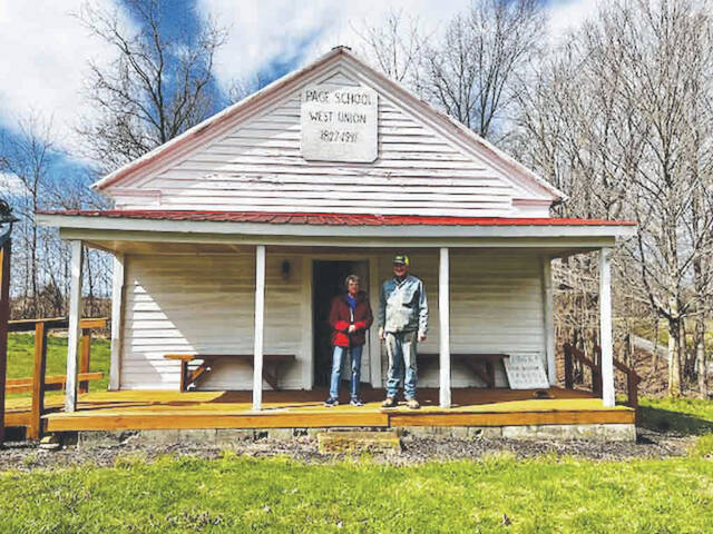 Mary Fulton and Phil Rhonemus stand in front of Page School. (Photo by Sherry Larson)