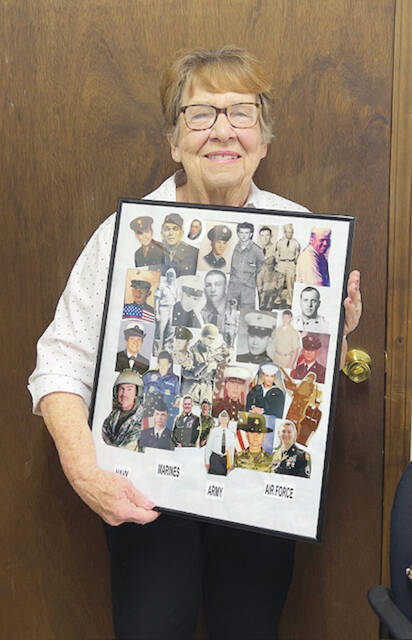 130623065_web1_Humphrey
Sue Humphrey holds a collage of her many family members who have served in the military. (Photo by Sherry Larson)